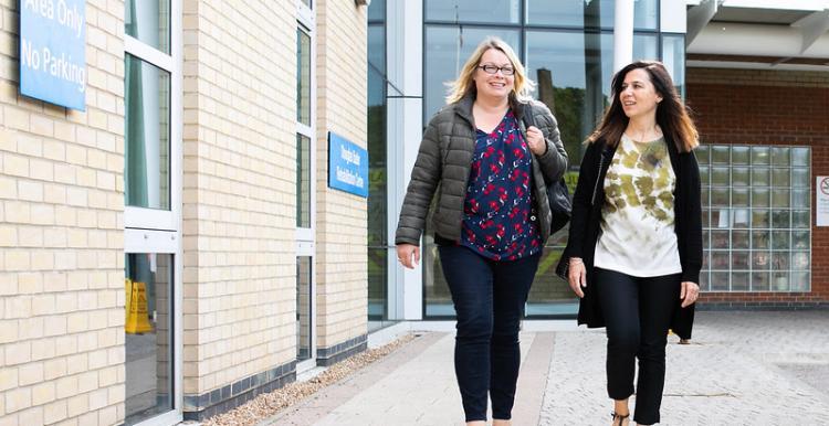 Two women outside hospital